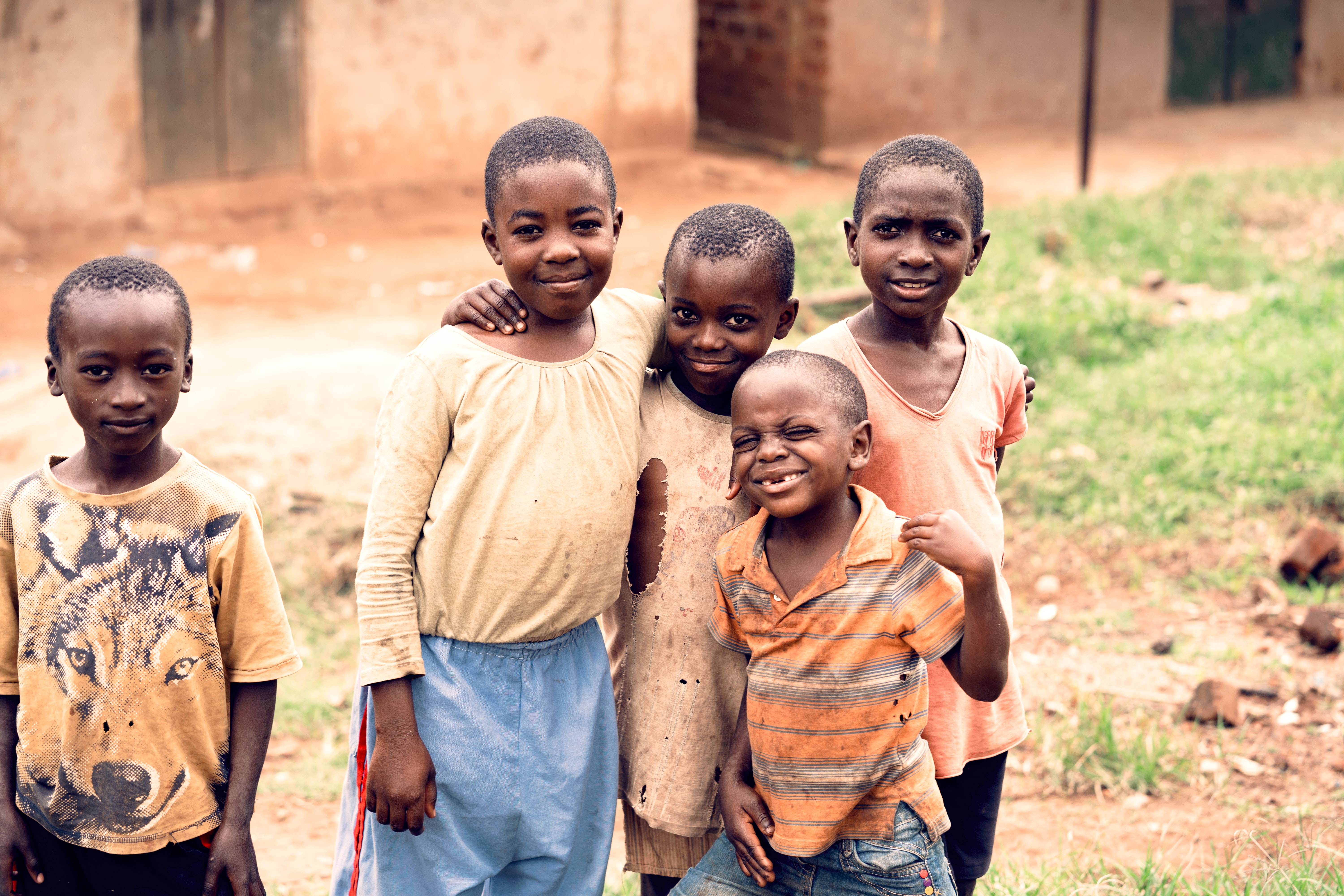 Four African kids smiling and looking straight to the camera